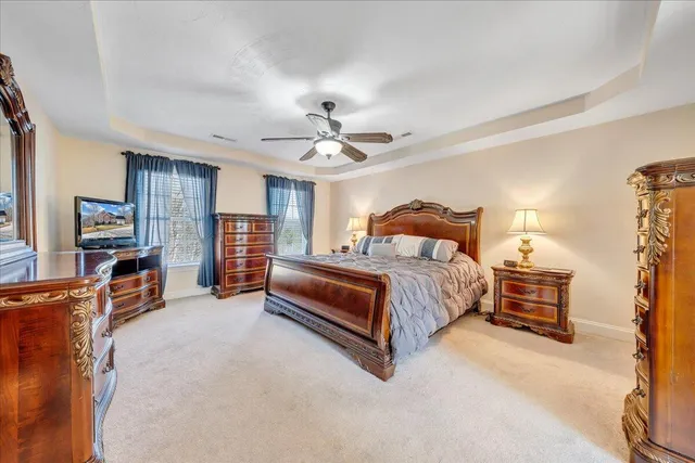 a spacious bedroom with a bed and a chandelier