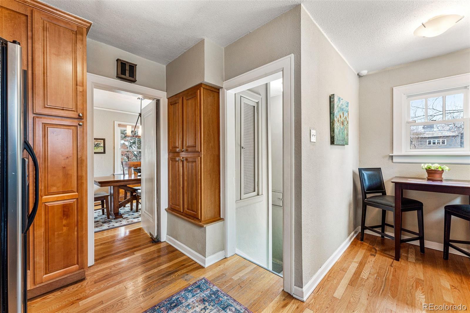 1639 Grape Street Denver, CO 80220 - Photo 15 of 39 a view of a livingroom with furniture wooden floor and a kitchen