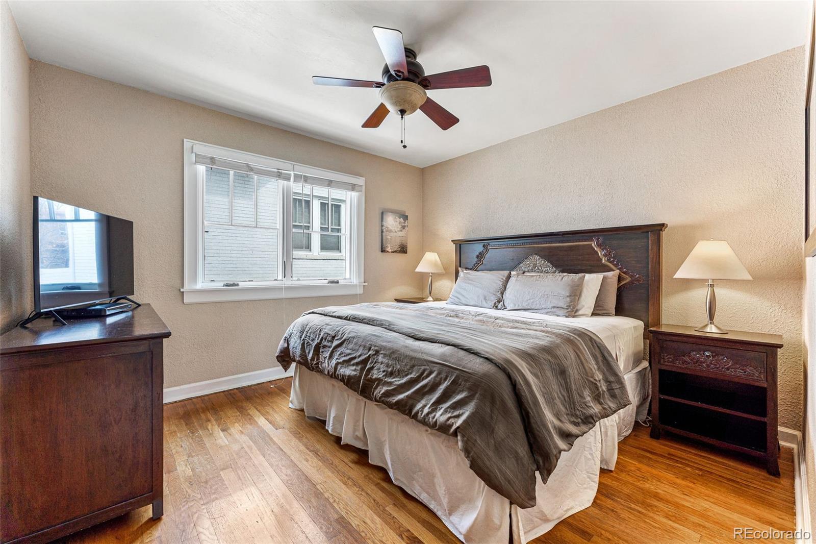 1639 Grape Street Denver, CO 80220 - Photo 16 of 39 a bedroom with a bed and a flat screen tv