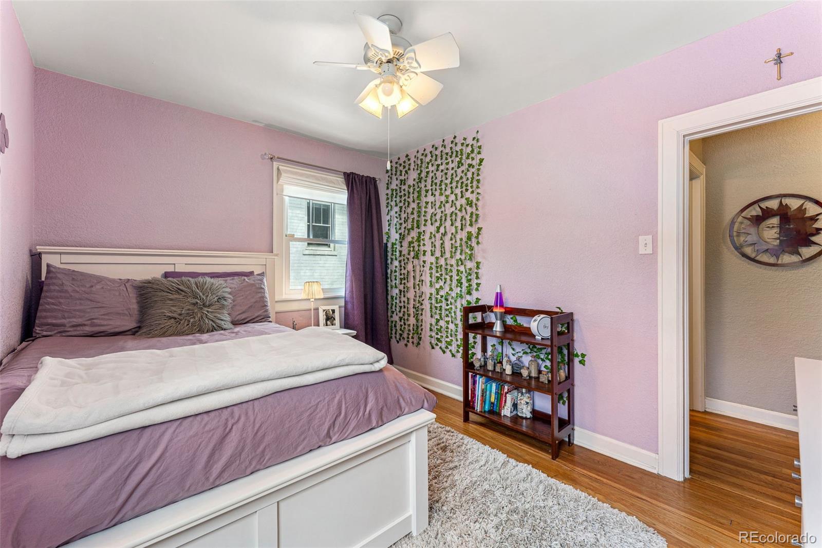 1639 Grape Street Denver, CO 80220 - Photo 19 of 39 a bedroom with a bed and a chandelier