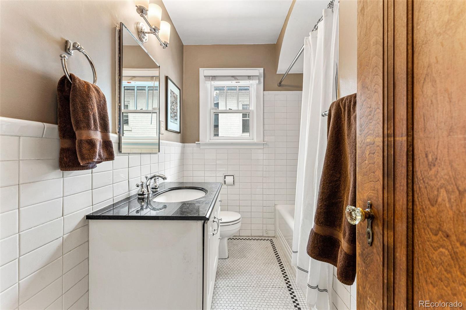 1639 Grape Street Denver, CO 80220 - Photo 20 of 39 a bathroom with a sink and a mirror