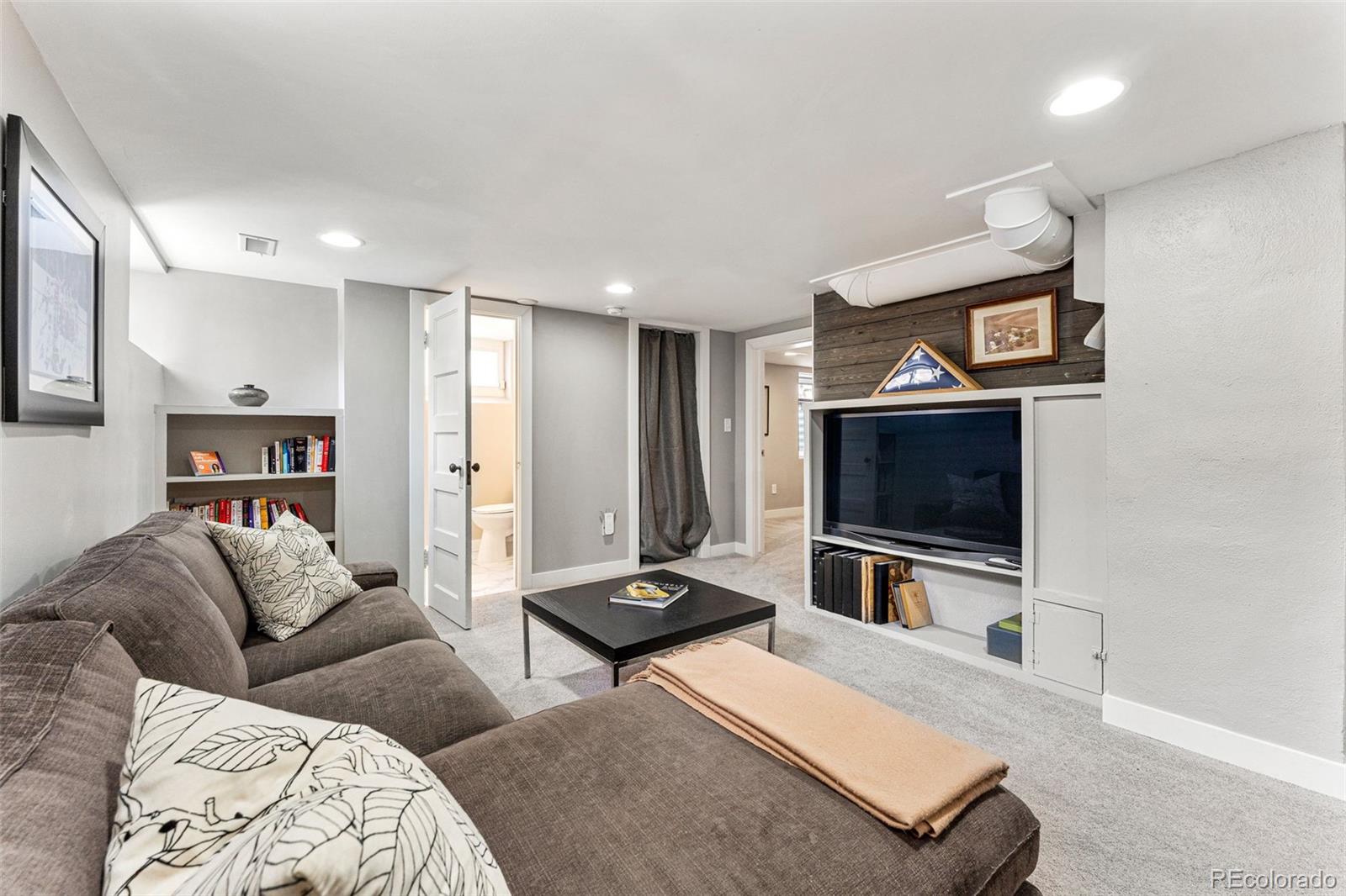 1639 Grape Street Denver, CO 80220 - Photo 22 of 39 a living room with furniture and a flat screen tv