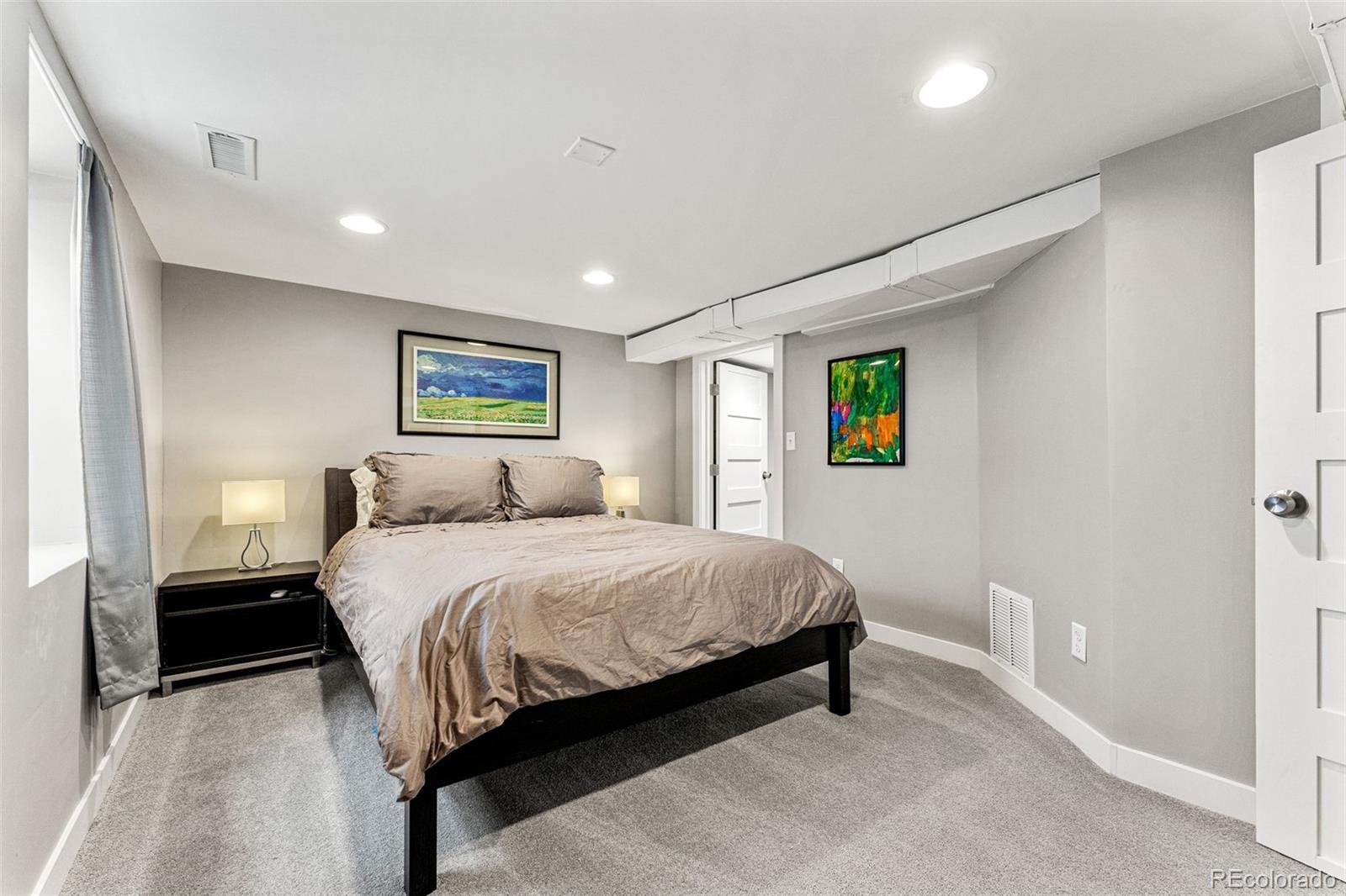 1639 Grape Street Denver, CO 80220 - Photo 25 of 39 a bedroom with a bed and a large mirror