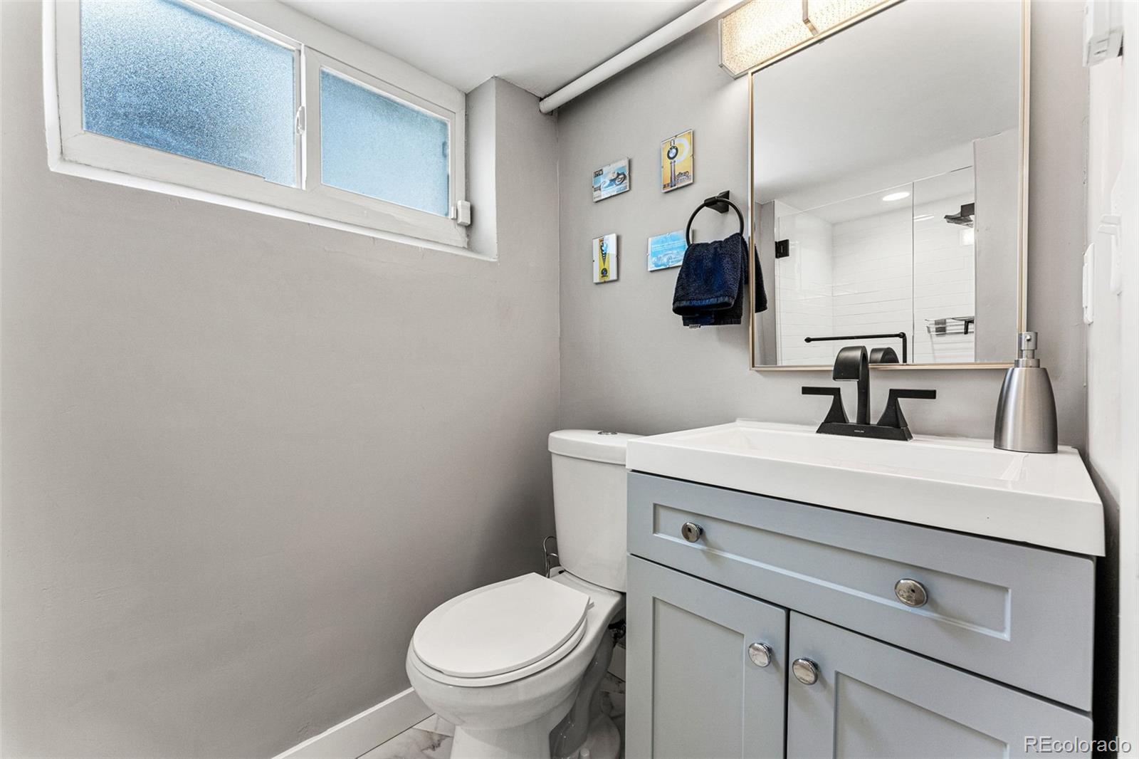 1639 Grape Street Denver, CO 80220 - Photo 28 of 39 a bathroom with a toilet sink and mirror
