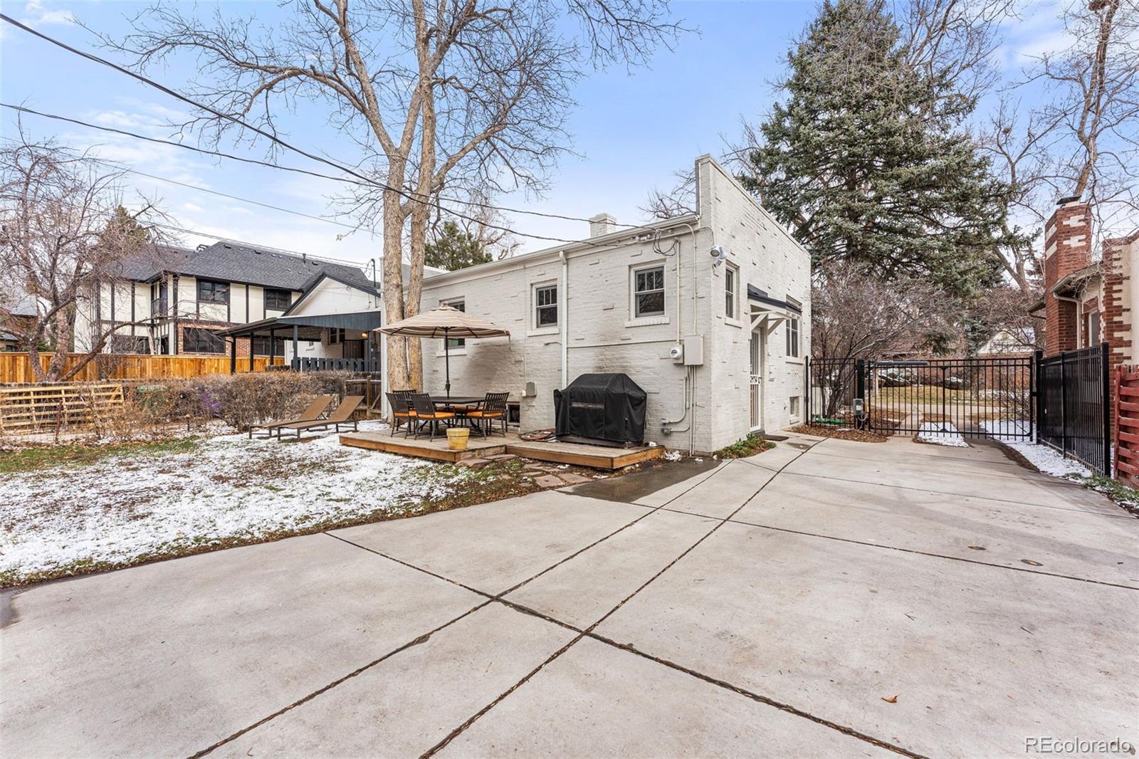 1639 Grape Street Denver, CO 80220 - Photo 32 of 39 a view of a white house with a snow on the road