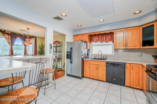 a kitchen with stainless steel appliances granite countertop a sink and cabinets