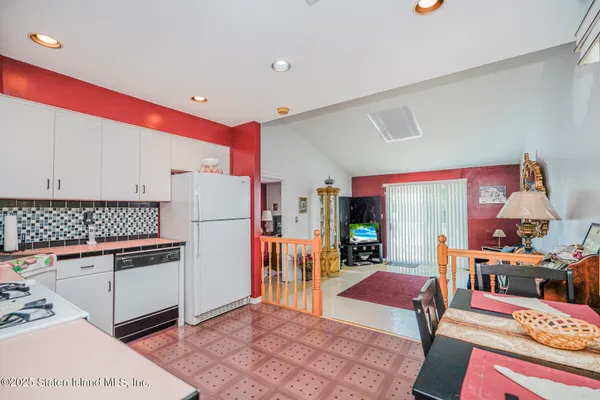 a kitchen with stainless steel appliances granite countertop a refrigerator and a stove