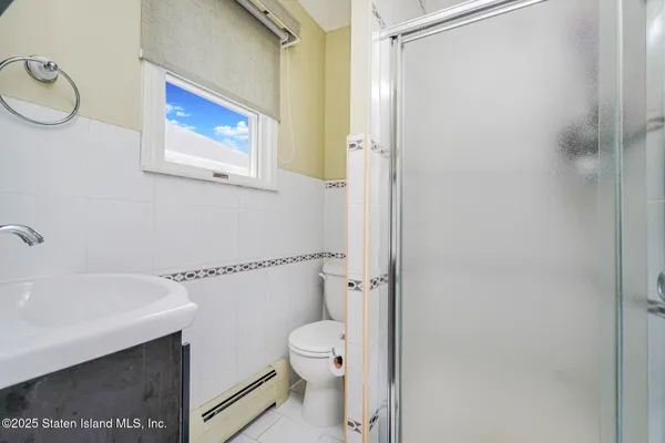 a bathroom with a toilet a sink and a shower