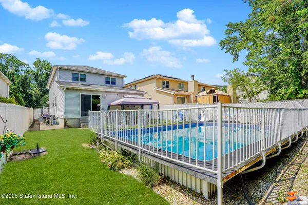 a view of a house with a yard and deck