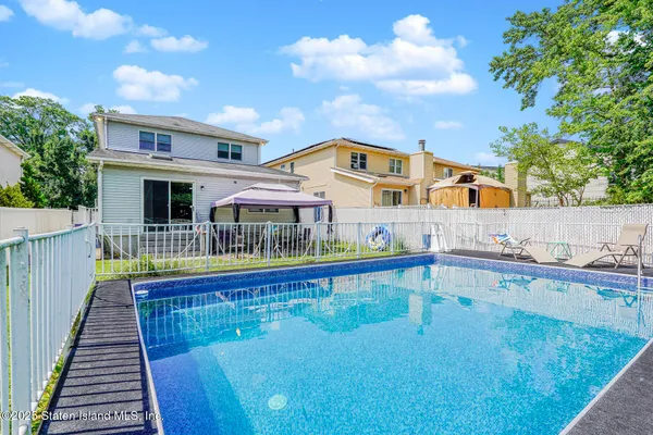 a swimming pool with outdoor seating