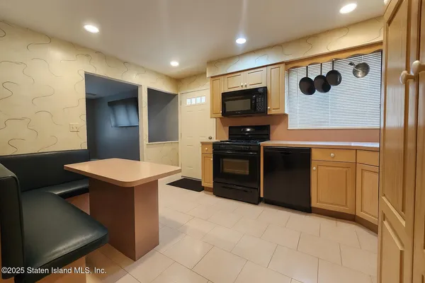 a kitchen with stainless steel appliances granite countertop a sink and a stove top oven