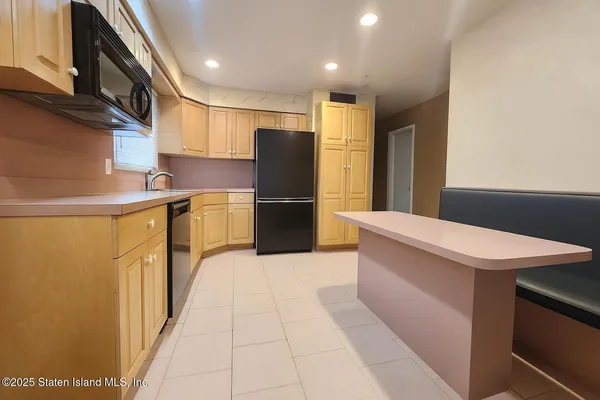 a kitchen with stainless steel appliances granite countertop a refrigerator and a stove