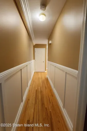 a view of hallway with wooden floor
