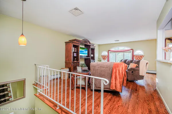 a bedroom with furniture and wooden floor