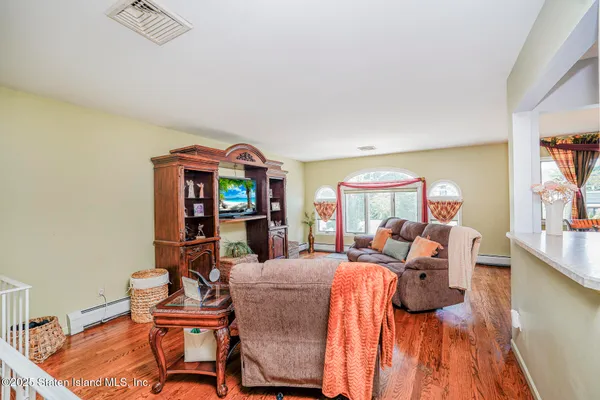 a living room with furniture a rug and a chandelier