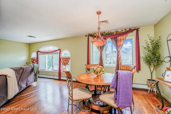 a view of a dining room with furniture window and wooden floor