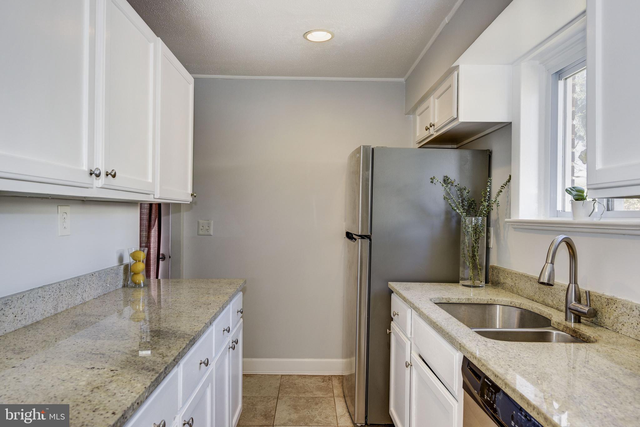 2802 Harris Avenue Silver Spring, MD 20902 - Photo 15 of 43 a kitchen with stainless steel appliances granite countertop a sink stove and refrigerator