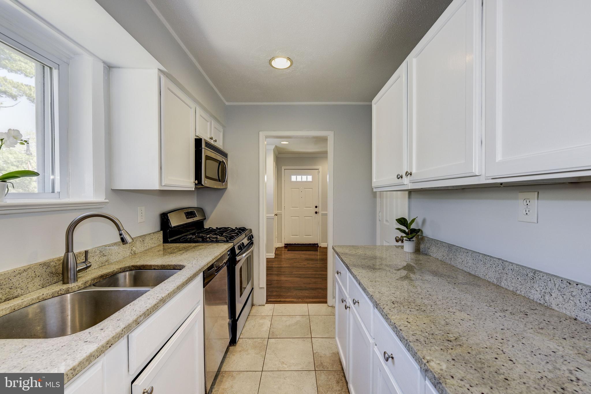 2802 Harris Avenue Silver Spring, MD 20902 - Photo 16 of 43 a kitchen with sink a stove and cabinets