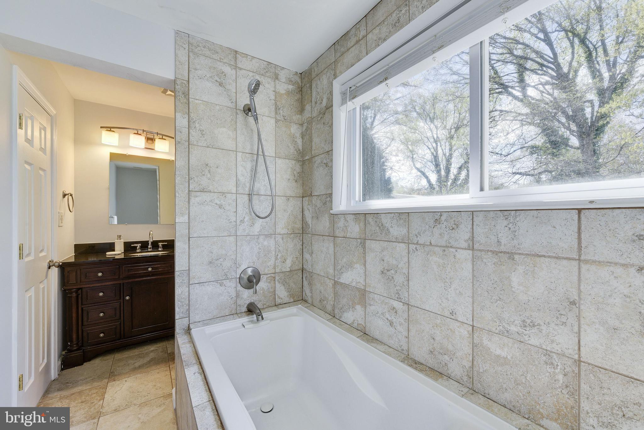 2802 Harris Avenue Silver Spring, MD 20902 - Photo 40 of 43 a bathroom with a bathtub and a shower