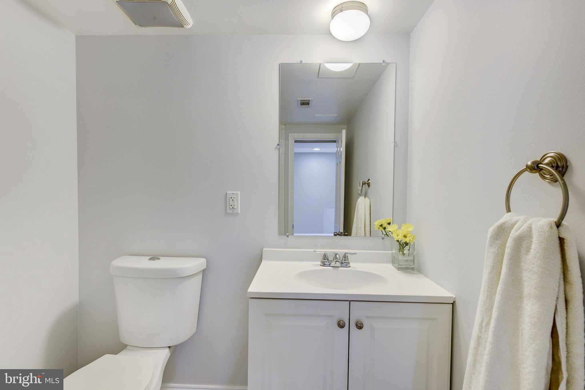 2802 Harris Avenue Silver Spring, MD 20902 - Photo 41 of 43 a bathroom with a sink vanity mirror and toilet