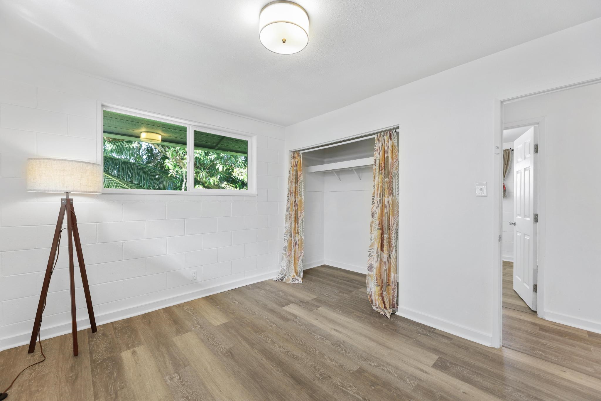 6 Kahope Place Haiku, HI 96708 - Photo 16 of 49 an empty room with wooden floor and windows