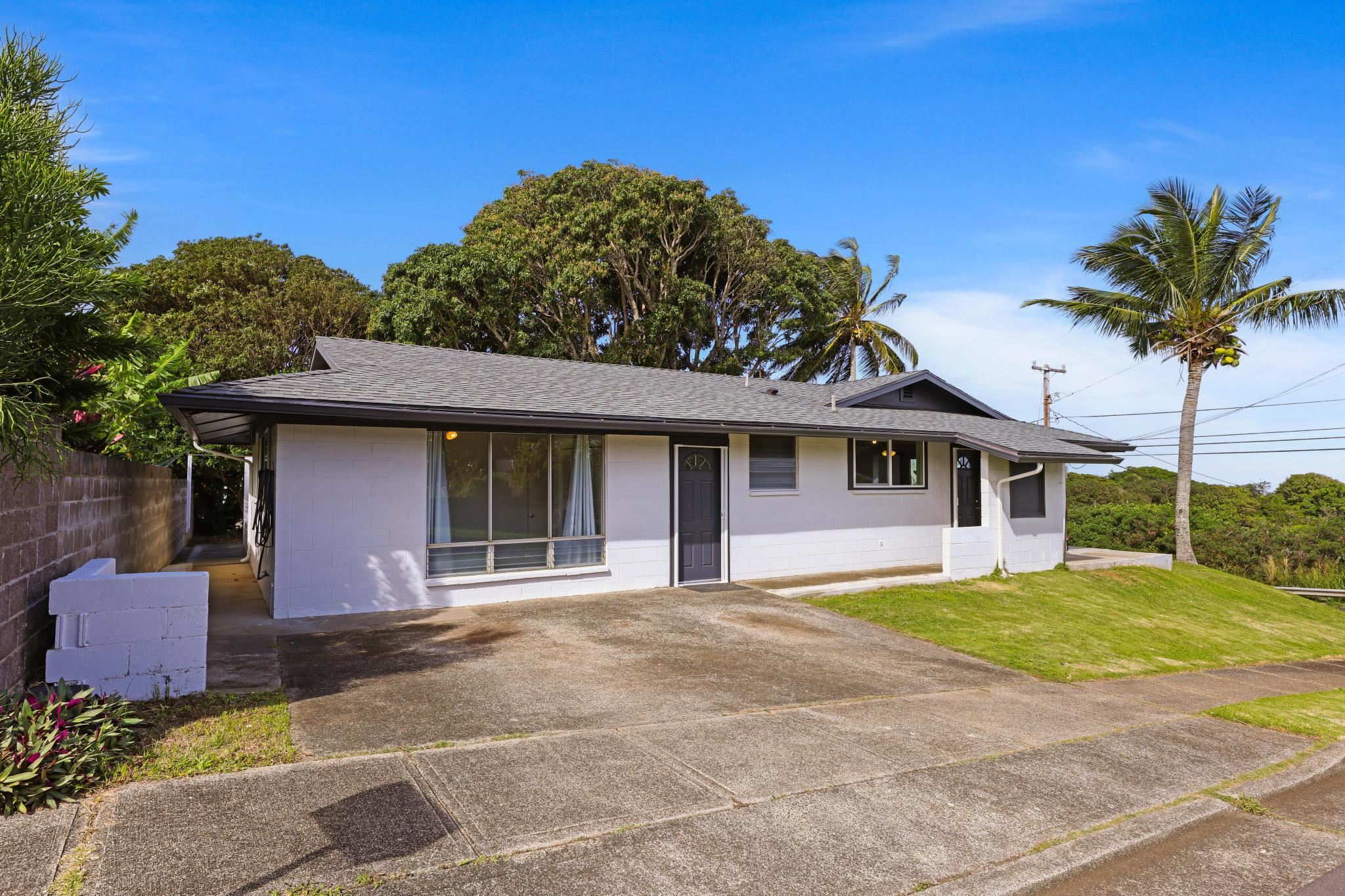6 Kahope Place Haiku, HI 96708 - Photo 43 of 49 a front view of a house with a yard and garage