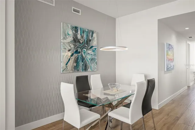 a view of a balcony with chairs and wooden floor