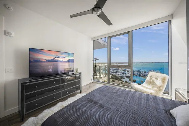 a living room with couches and a dining table with kitchen view