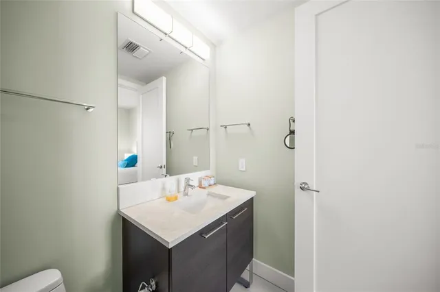a view of staircase with railing and a chandelier
