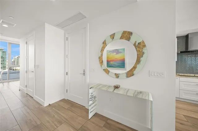 a large kitchen with kitchen island a stove a sink dishwasher and a dining table with wooden floor