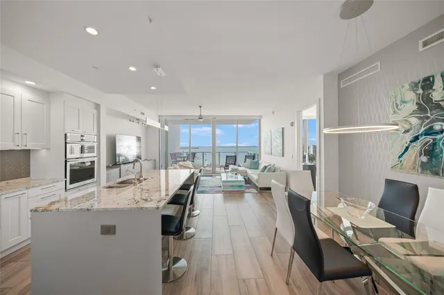 a dining room with furniture and wooden floor