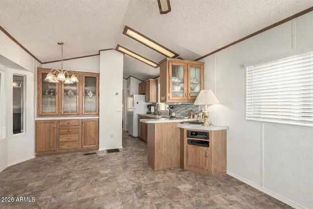 a living room with furniture a dining table and a large window