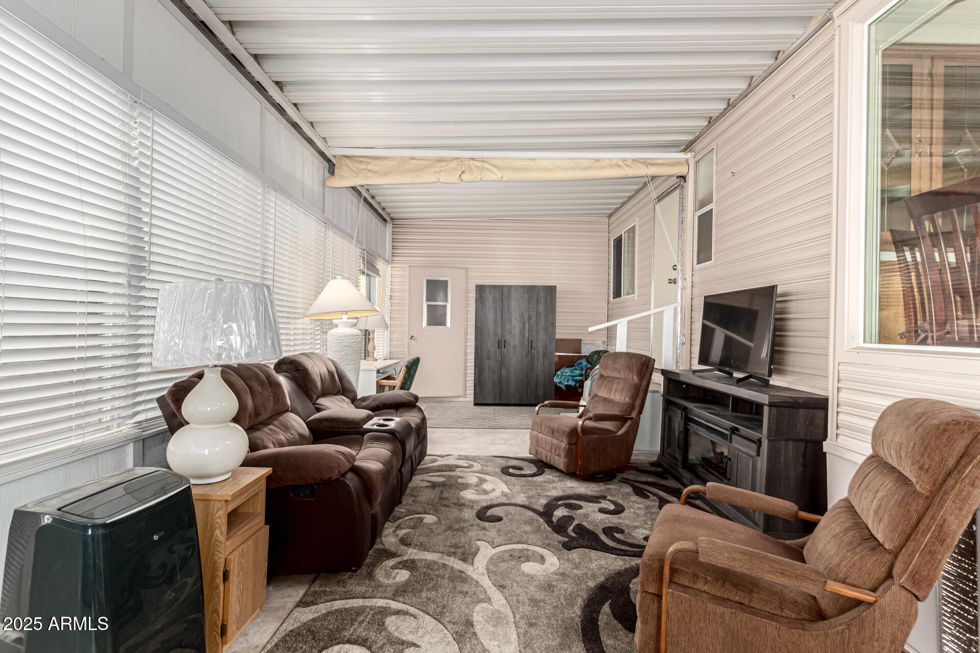2920 South Cree Drive Apache Junction, AZ 85119 - Photo 24 of 55 a living room with furniture a fireplace and a flat screen tv