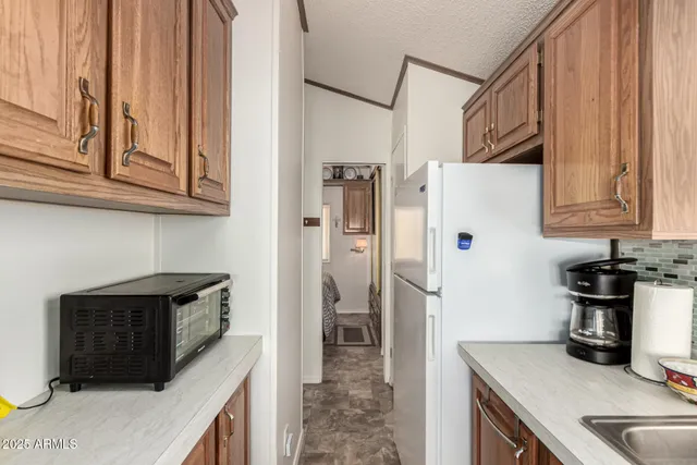 a kitchen with a sink stove and refrigerator