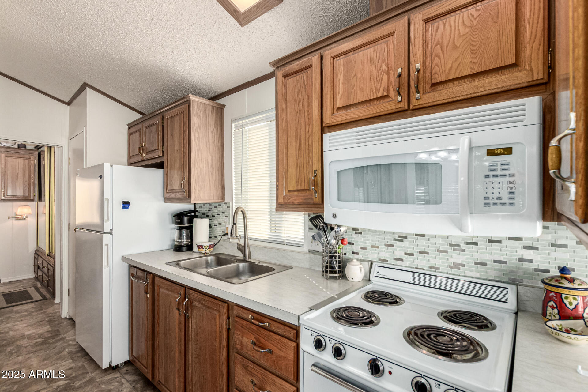 2920 South Cree Drive Apache Junction, AZ 85119 - Photo 29 of 55 a kitchen with a sink stove and refrigerator