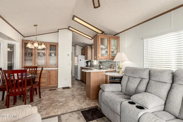 a living room with furniture a dining table and a large window