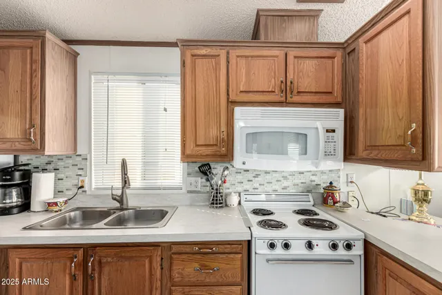 a kitchen with stainless steel appliances a stove sink and cabinets