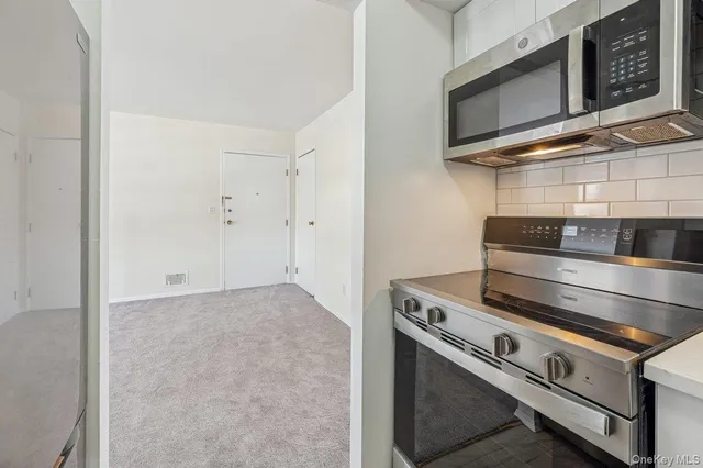 a stove top oven sitting inside of a kitchen