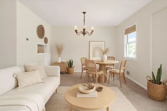 a living room with furniture a window and a chandelier