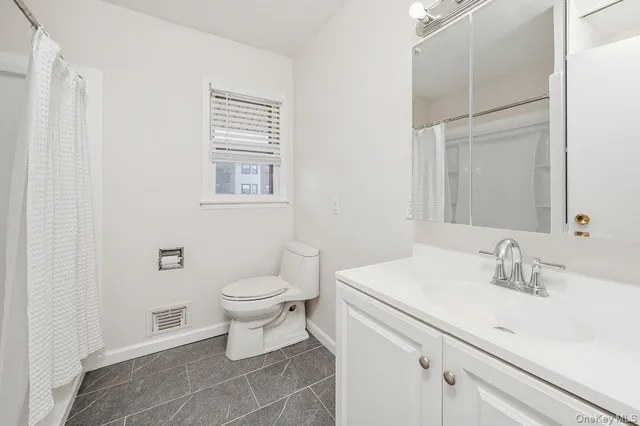 a bathroom with a sink toilet and vanity