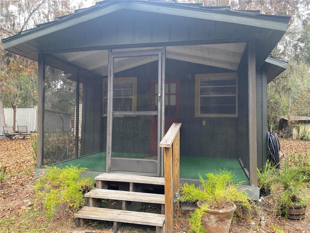 8093 Breezy Point Road East Keystone Heights, FL 32656 - Photo 24 of 34 a front view of a house with a yard