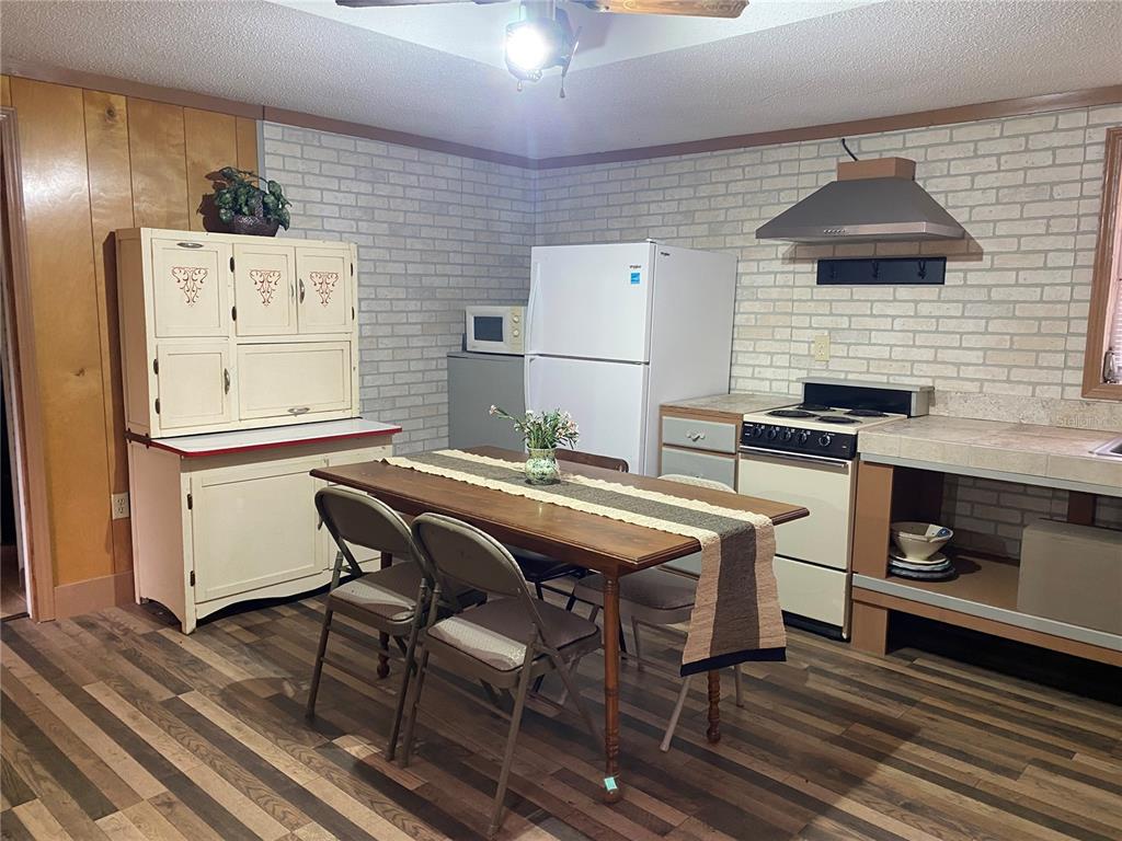 8093 Breezy Point Road East Keystone Heights, FL 32656 - Photo 26 of 34 a kitchen with stainless steel appliances kitchen island granite countertop a sink and cabinets