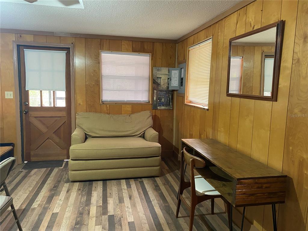 8093 Breezy Point Road East Keystone Heights, FL 32656 - Photo 27 of 34 a living room with furniture and a gate