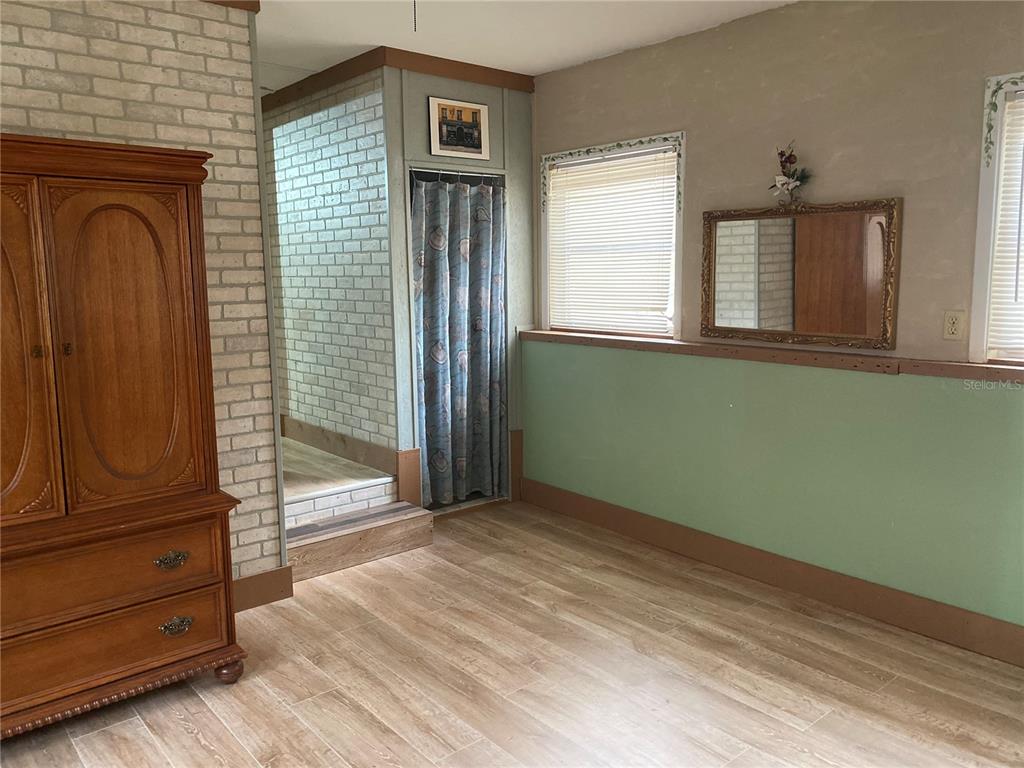 8093 Breezy Point Road East Keystone Heights, FL 32656 - Photo 30 of 34 a view of empty room with wooden floor and fan