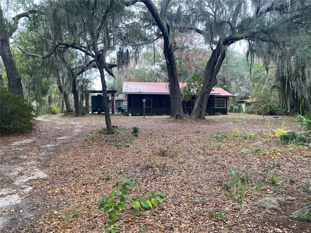 8093 Breezy Point Road East Keystone Heights, FL 32656 - Photo 31 of 34 a house with trees in front of it