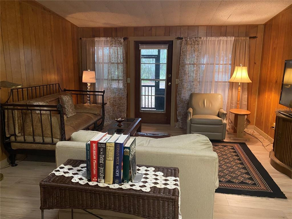 8093 Breezy Point Road East Keystone Heights, FL 32656 - Photo 4 of 34 a living room with furniture fireplace and a window