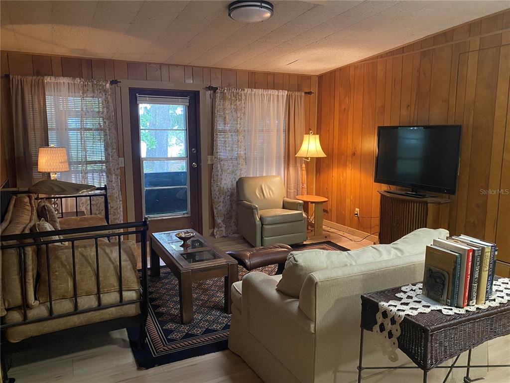 8093 Breezy Point Road East Keystone Heights, FL 32656 - Photo 5 of 34 a living room with furniture and a flat screen tv