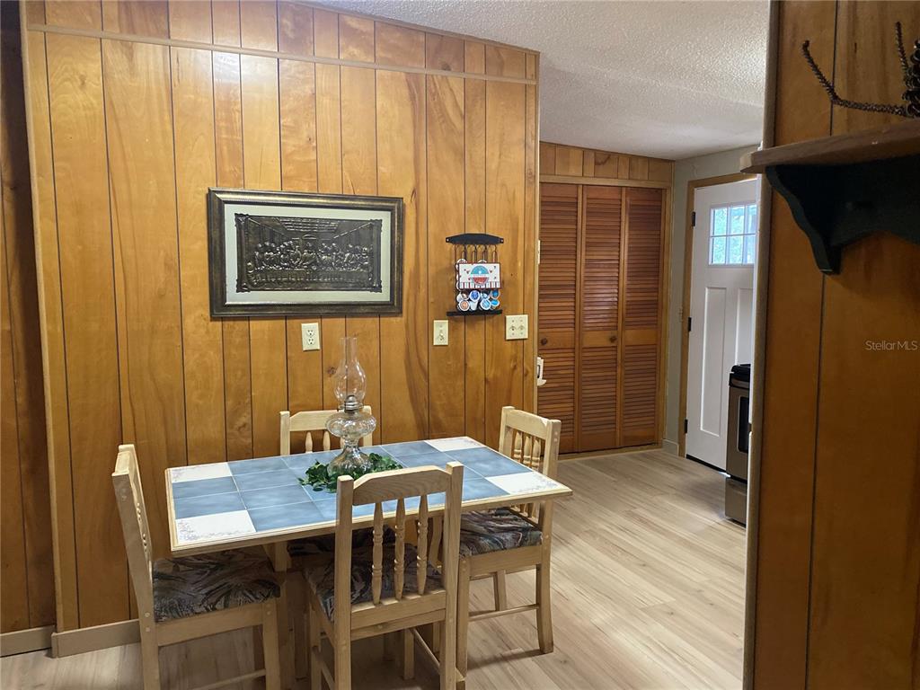 8093 Breezy Point Road East Keystone Heights, FL 32656 - Photo 8 of 34 a view of a dining room with furniture and wooden floor