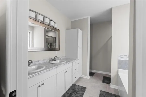 a bathroom with a bathtub and a shower