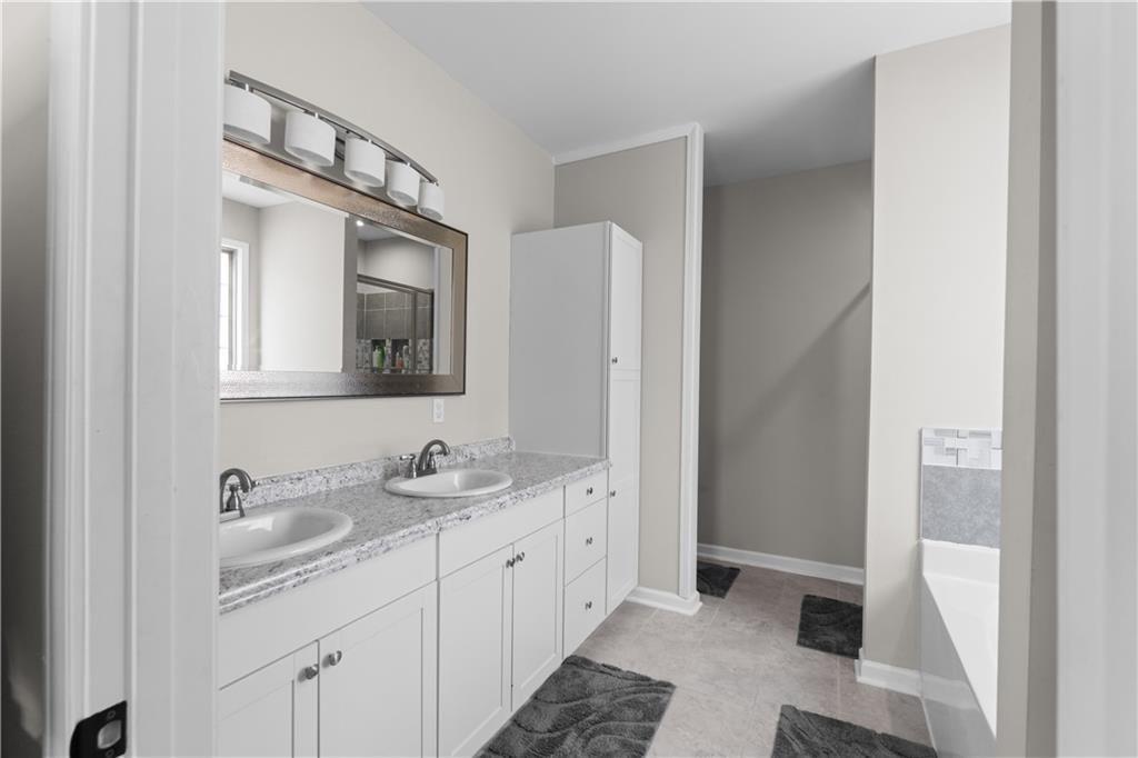 2117 Treehaven Court Decatur, GA 30035 - Photo 11 of 23 a bathroom with a double vanity sink and mirror